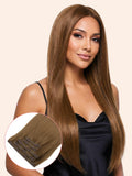Woman with long brown hair extensions on a beige background