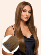Woman with long brown hair extensions on a beige background