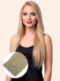 Woman with long blonde hair extensions on a beige background